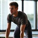 Michael B., Sales Director, performing an online workout at home.